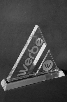 Werbe crystal triangle award with a smaller triangle and engraved Werbe logo, on a dark background